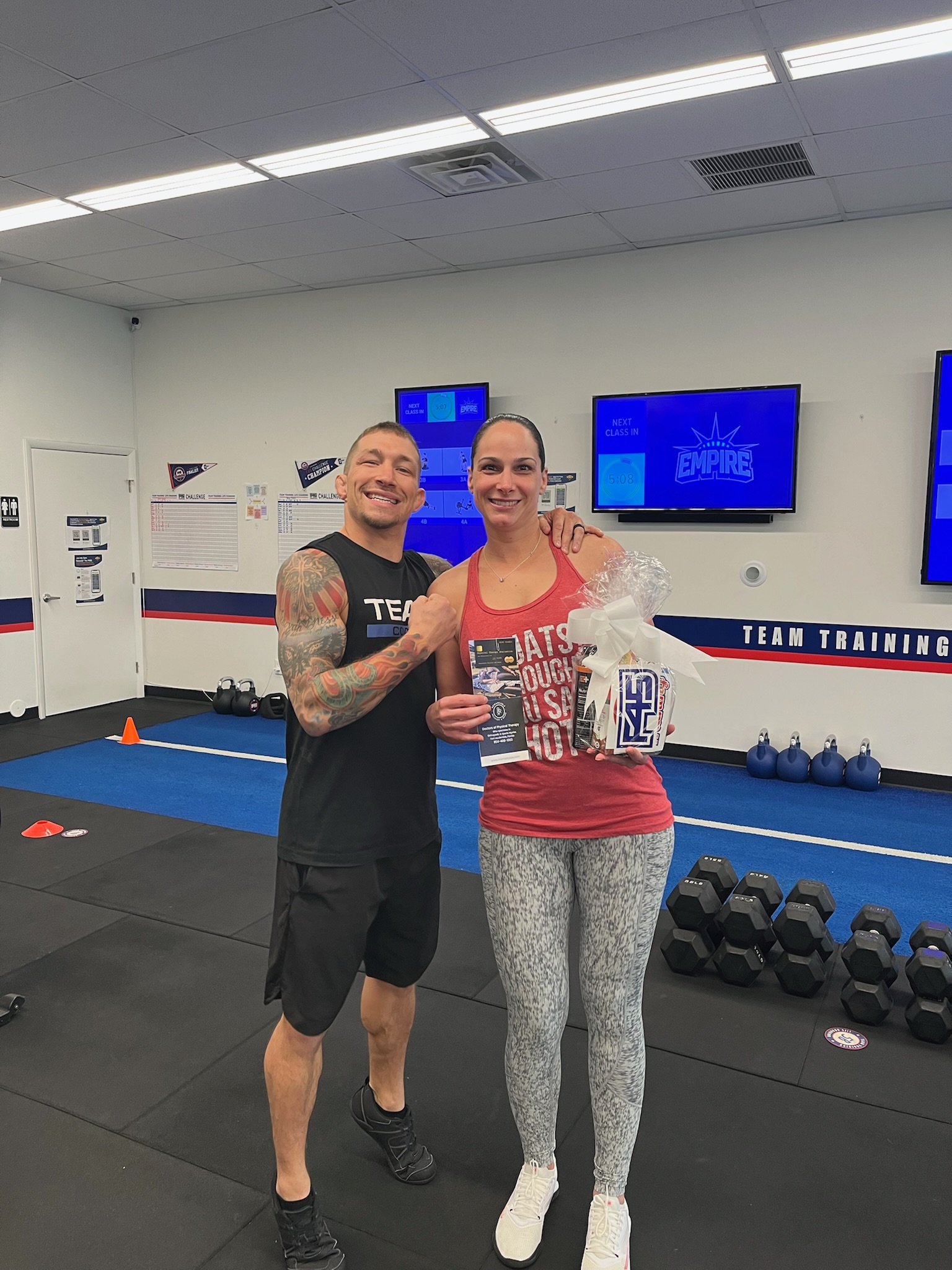 F45 Pompano member and coach celebrating at the studio
